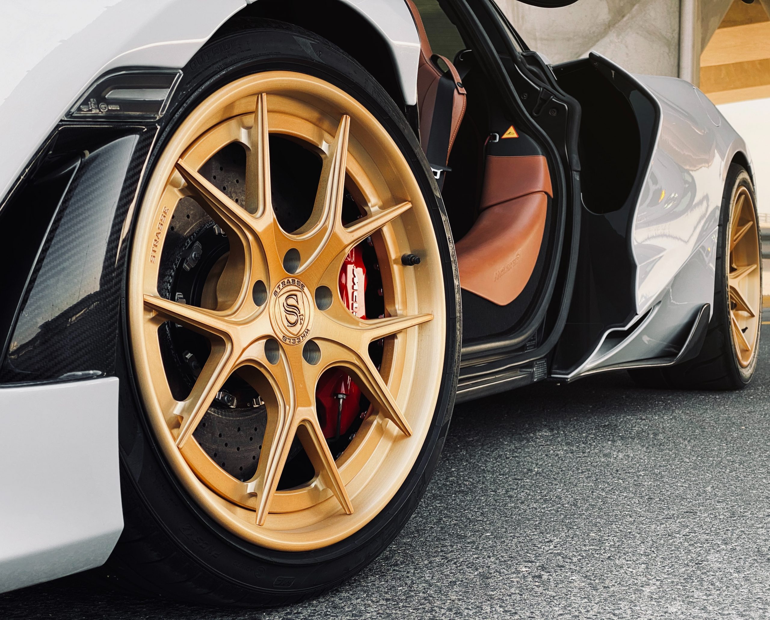 McLaren with gold Strasse forged wheels — wheel coating and detailing