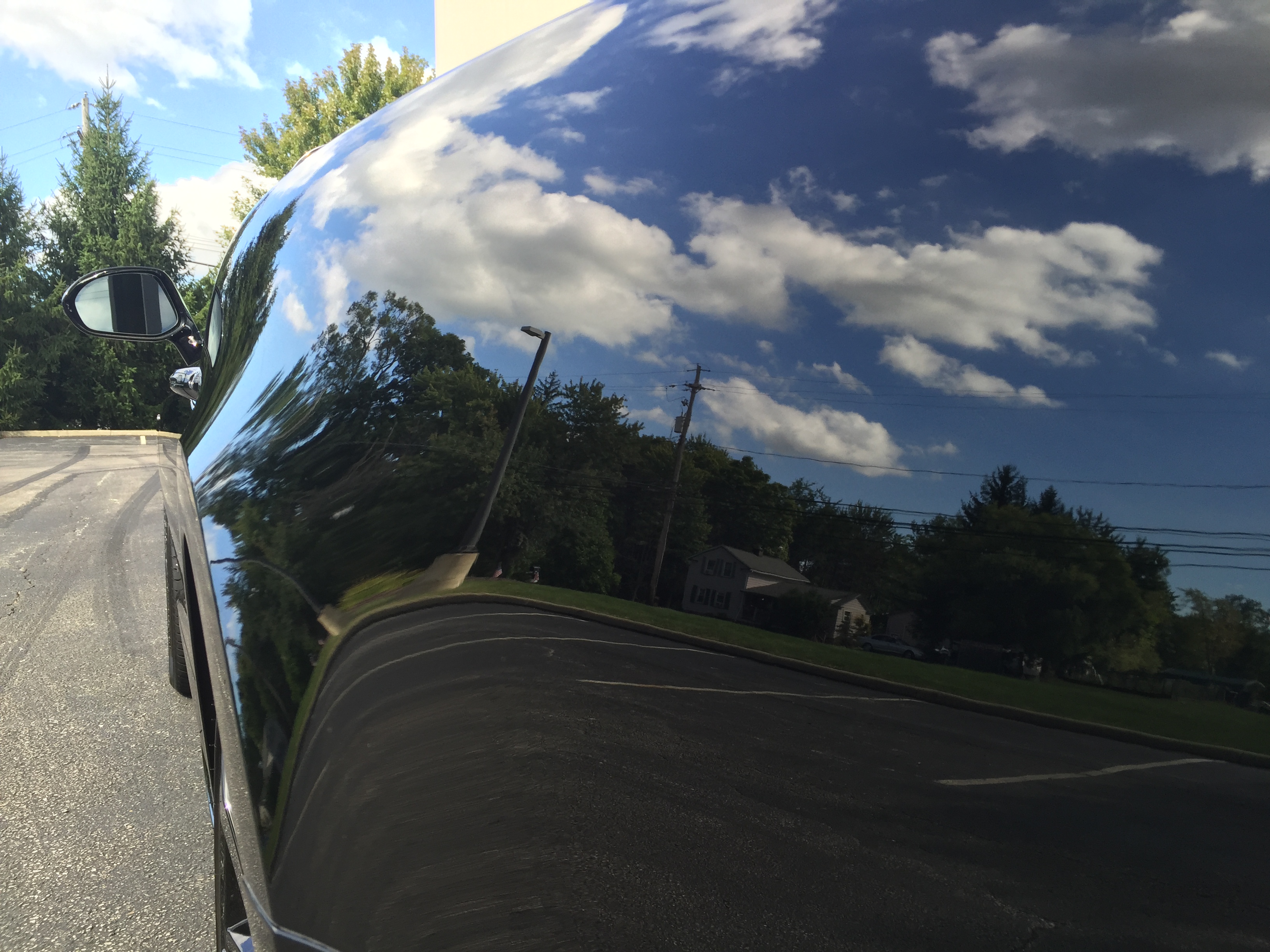 Bentley Continental GT — mirror-finish fender reflecting the sky after ceramic coating