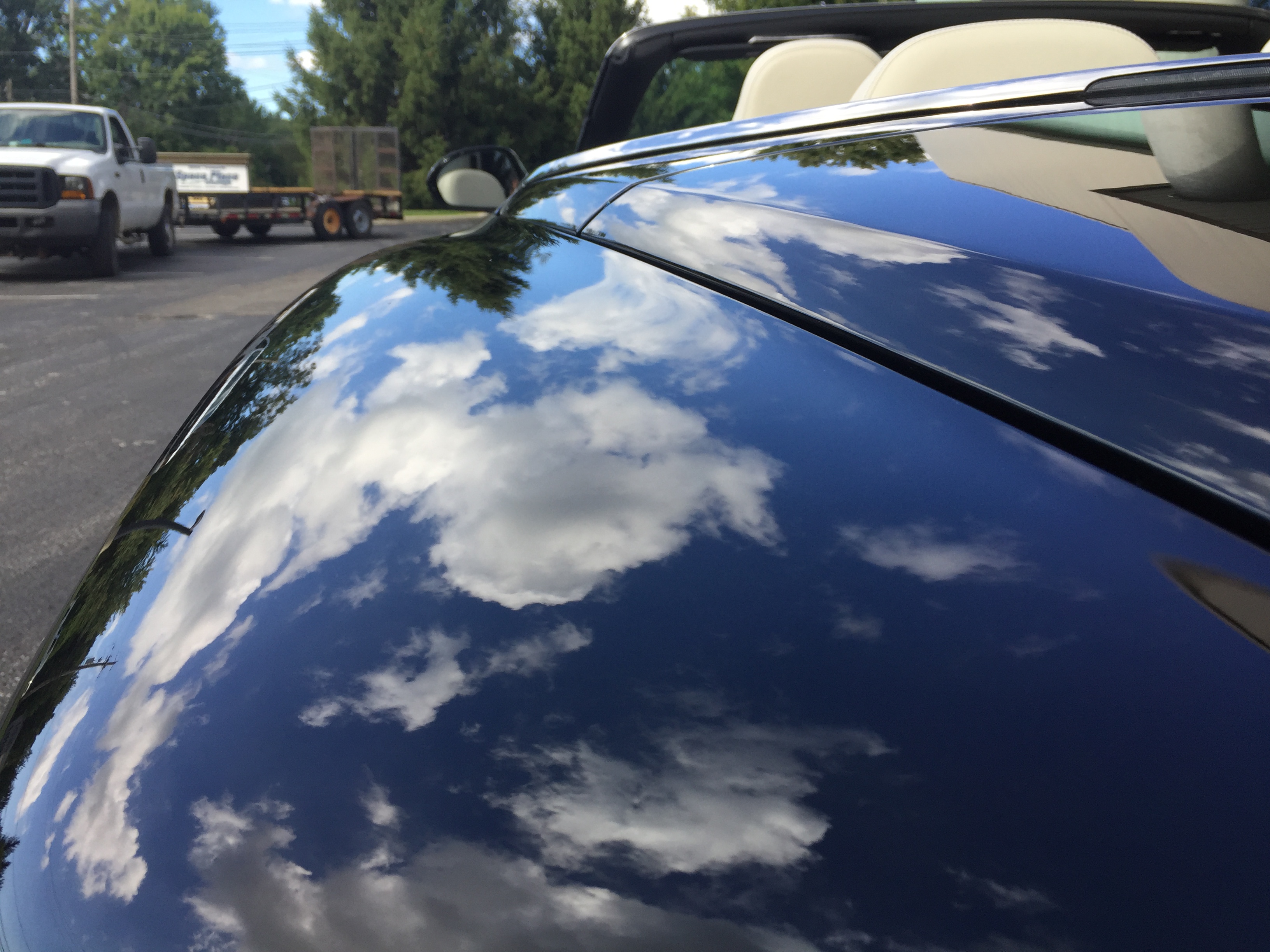 Bentley Continental GT — hood reflecting clouds after paint correction and ceramic coating