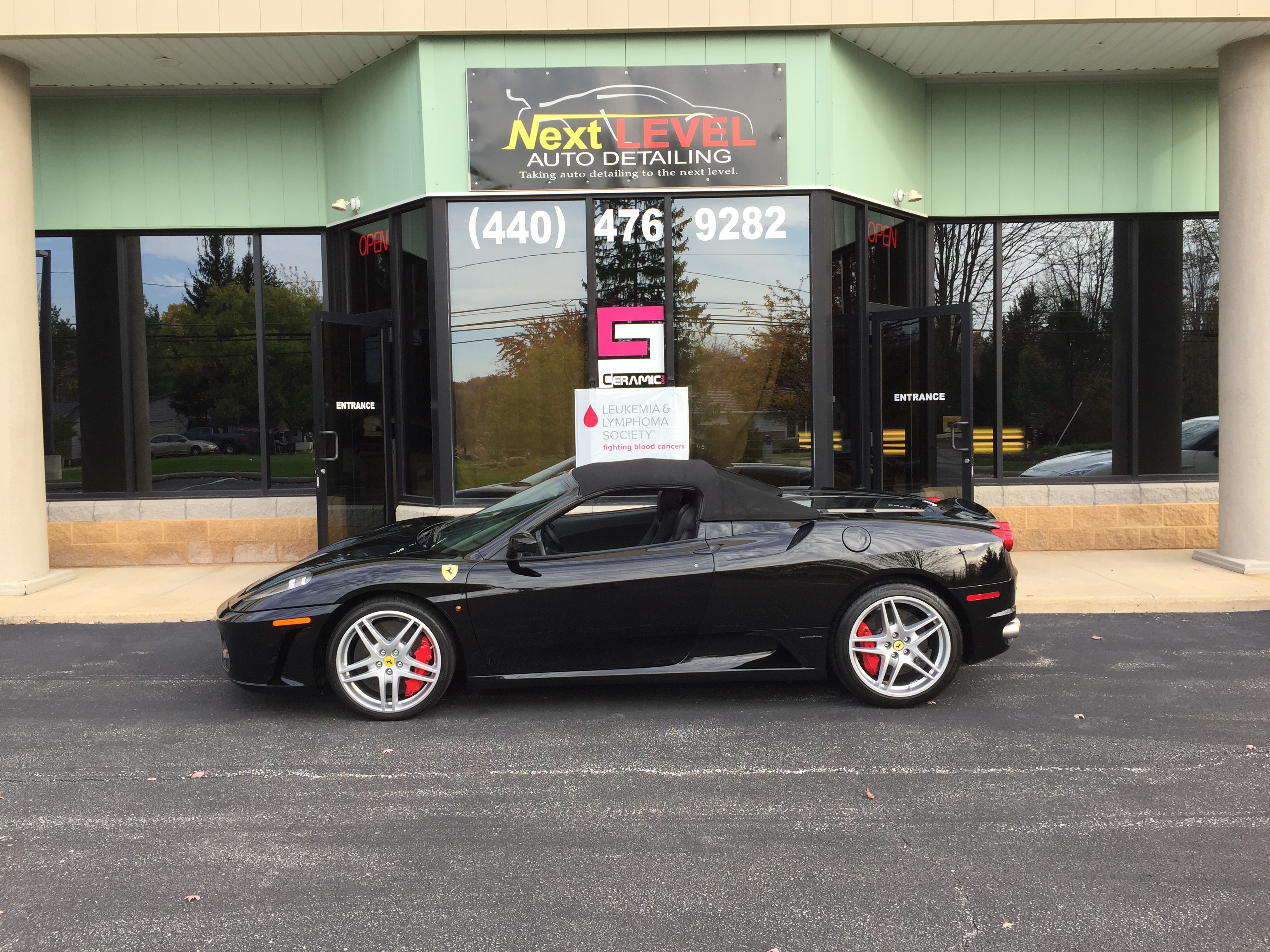Ferrari F430 Spider — side profile at the Next Level Auto Detailing shop